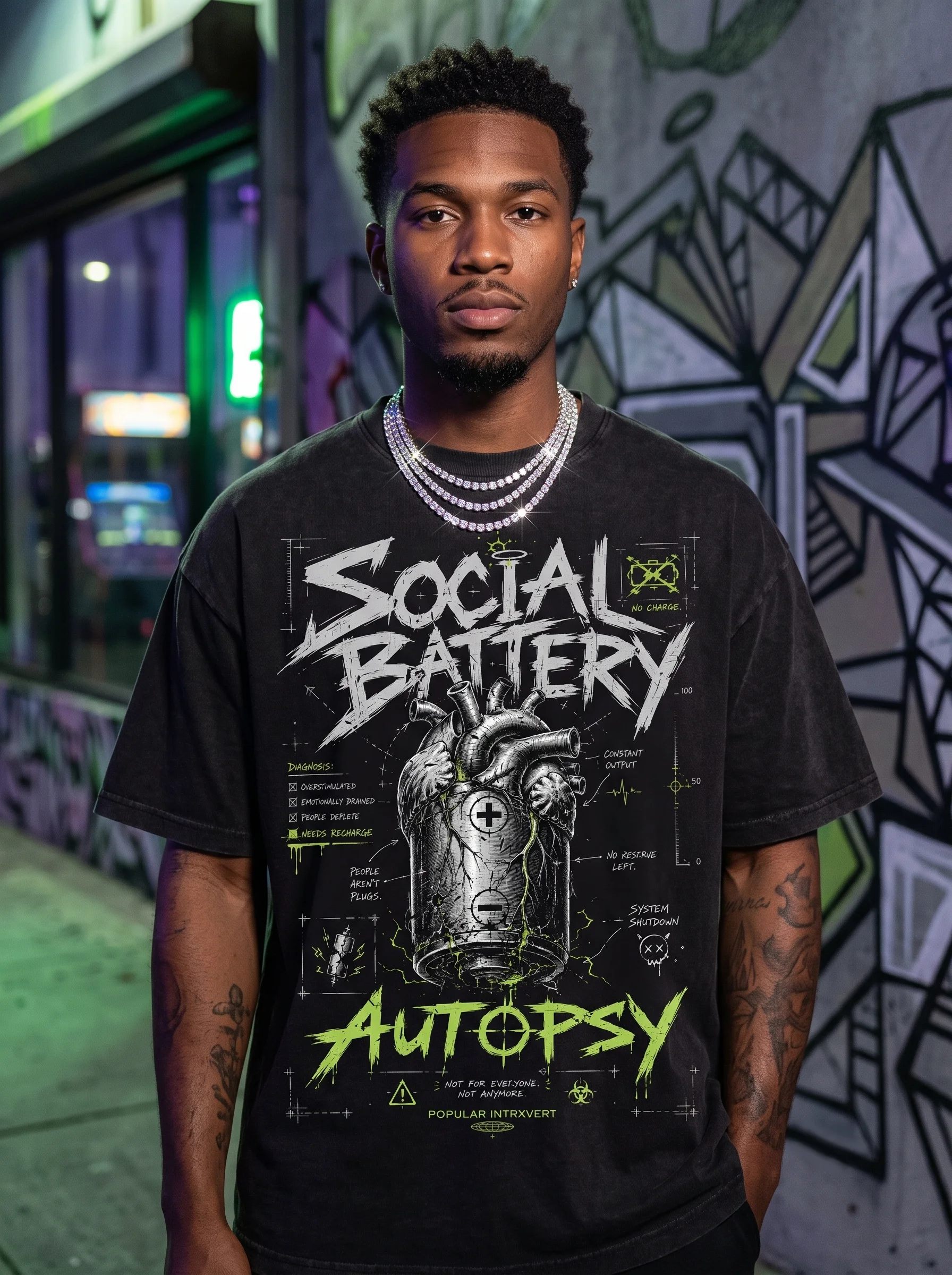 Model wearing the Popular Intrxvert Social Battery Autopsy graphic tee at night